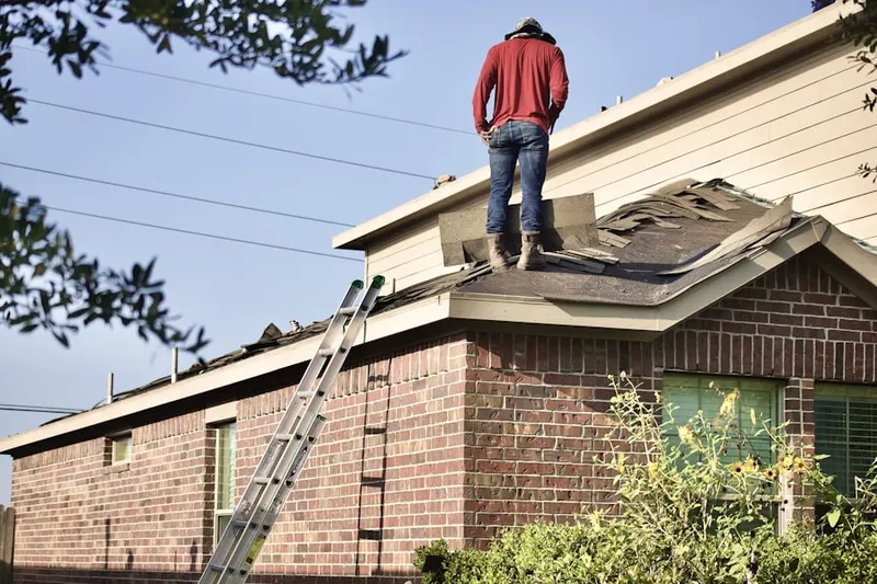 Professional roofer working on a residential roof in Columbia Heights East